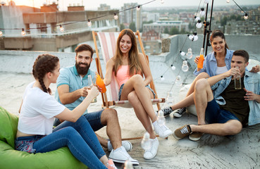 Friends having party on top of the roof. Fun, summer, city lifestyle and friendship concept