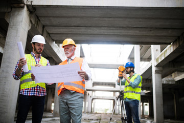 Construction engineer with foreman worker checking construction site