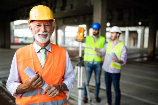 Engineer, foreman and worker discussing in building construction site