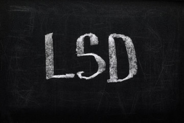 top view of black chalk board with lettering LSD