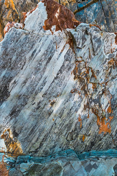 Abstract rock pattern in gray tones and orange streak at beach in Bay of Biscay, Spain