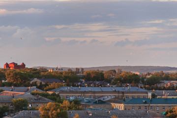 Small soviet city on sunset.The sun comes out from behind the clouds.