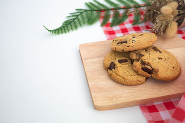 chocolate chip cookies with red white napkin and white background