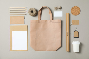 Mockup. Corporate stationery, tote bag and paper cup on grey background. Flat lay