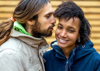 guy with an african american girl in love in autumn park walk at sunset