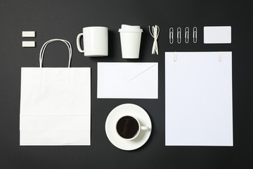Flat lay composition with blank stationery on black background, copy space