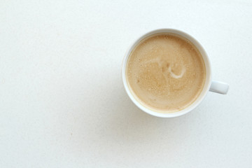 white wide cup of coffee, cappuccino with milk, cocoa on a white table, top view, save space