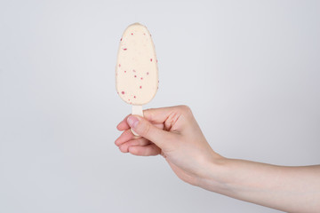 Side profile closeup view photo of hand getting giving taking ice cream from cafe isolated grey background copy space