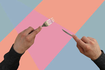 hands with cutlery fork and knife on a geometric background, coral, pink, blue