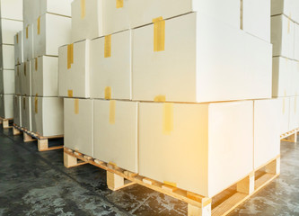 stack cardboard boxes on wooden pallets.