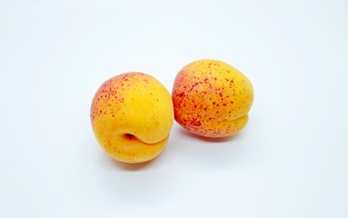 Delicious juicy apricots are located on a white background