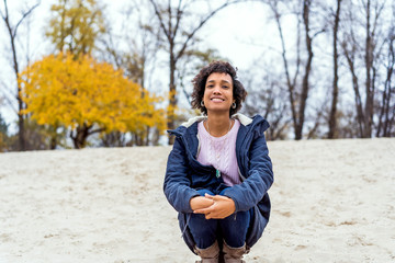 afro girl in autumn park outdoors smiling