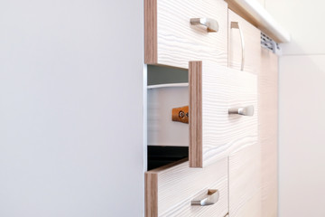 a wooden wardrobe drawer front, metal handle