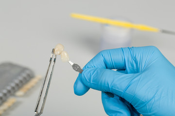 close up of color check of artificial dentition in a dental laboratory