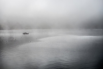 Fototapeta premium Fishing in the morning fog on the lake in japan
