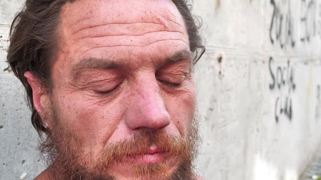 Down-and-out person on the street. Real person with no fixed abode, homeless man