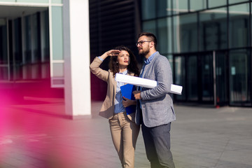 Male and female architects discussing a new project 