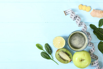 Green smoothie and fresh vegetables on the table for the detox organism top view.