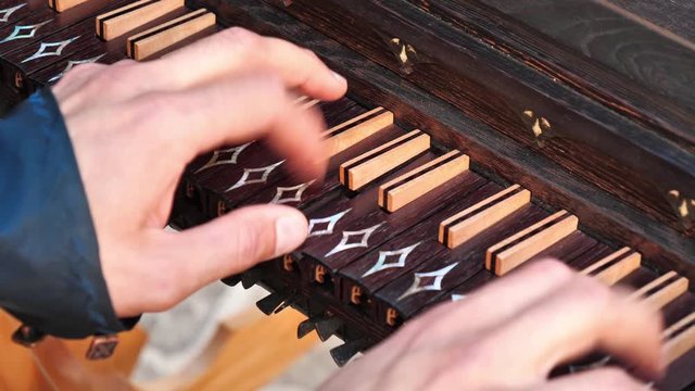 Man playing harpsichord close up