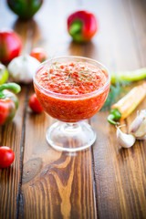 homemade hot adjika from tomatoes, hot and sweet peppers with spices