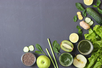 Green smoothie and fresh vegetables on the table for the detox organism top view.