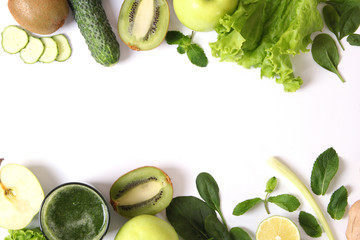 Green smoothie and fresh vegetables on the table for the detox organism top view.