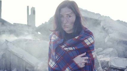 portrait of dirty face woman survivor after fire or natural disaster looking at camera