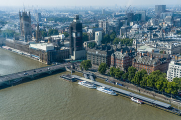 Aerial view of London with Westminster Bridge, Palace of Westminster and Big Ben being renovated in the distance.