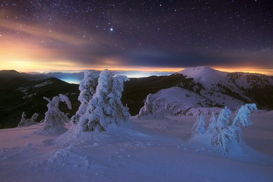 Starry night in winter mountains