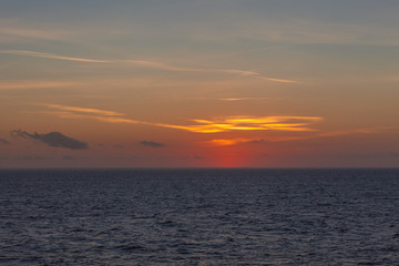 Beautiful orange sky right after sunset behind the italian coast