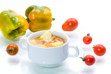 vegetable soup with noodles, tomatoes, peppers and other vegetables in a plate