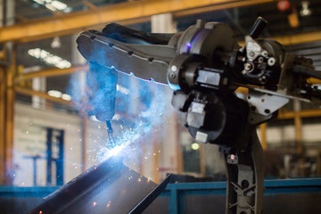 Welding robots movement in factory close up