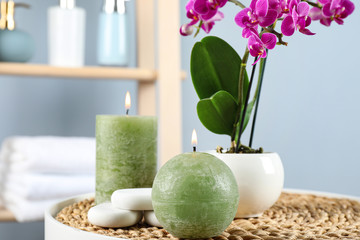 Spa accessories and blooming orchid on table indoors