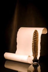 Unrolled papyrus scroll with inkwell and quill pen