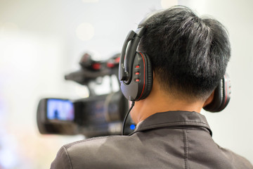 cameraman with headphones with HD camcorder