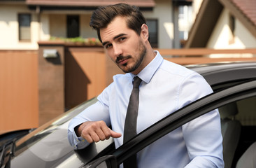 Fototapeta na wymiar Attractive young man near luxury car outdoors