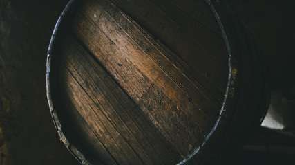 Whiskey barrel closeup in dark interior
