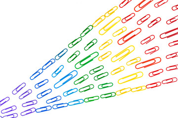 Rainbow colored paperclips on white background as symbol for workplace diversity, gay pride