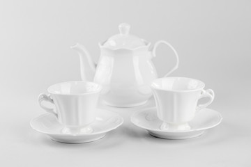 Fototapeta na wymiar Cup of tea with teapot isolated on white background