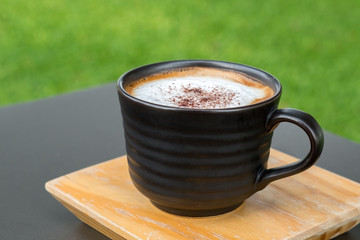 Latte Coffee in a cup on wooden table and Coffee shop