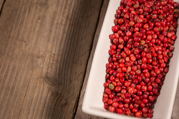 a pile of pink peppercorn in a rectangular pot