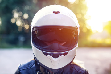 Woman wearing a motorcycle helmet with sunglasses