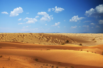Fototapeta na wymiar Desert background or landscape with blue sky and clouds