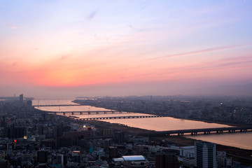 Beautiful Sunset sky over Osaka city and river aerial view, cityscape background