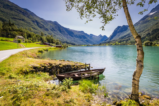 Panoramic view with rowing boat and white berk tree alongLake Oldevatnet in valley Oldedalen in Norway, Scandinavia