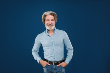 Portrait of handsome mature man on blue background