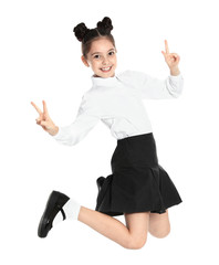 Happy girl in school uniform jumping on white background