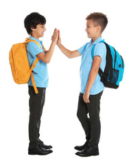 Happy boys in school uniform on white background