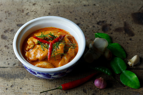 Panaeng Curry with Pork in porcelain bowl on wood background ,famous thai food