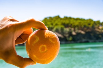 Smiling face pictured on orange. Healthy food concept 